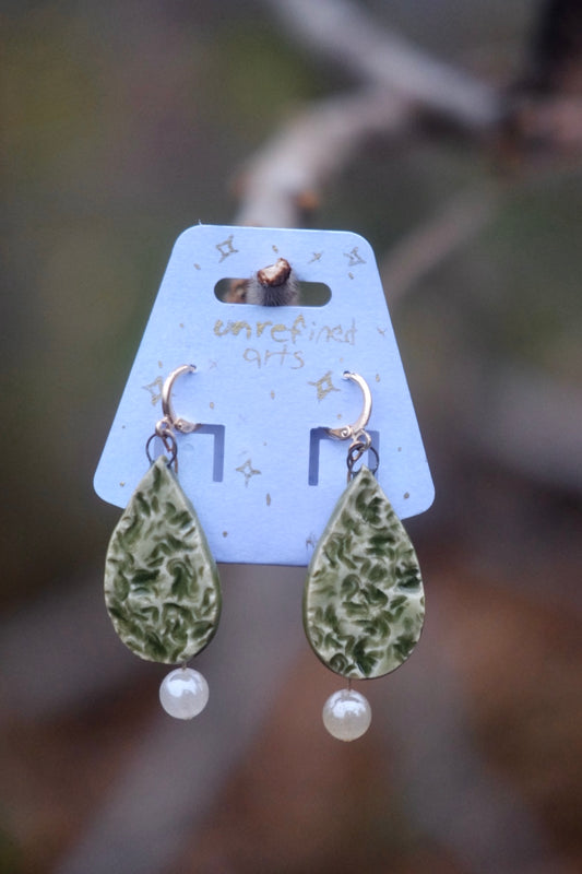 green teardrop shaped ceramic earrings with sunstone accents